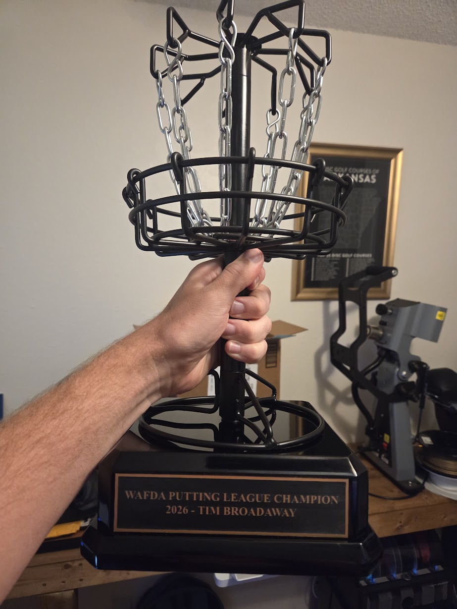 A large trophy topped with a disc golf basket for the WAFDA Putting League champion
